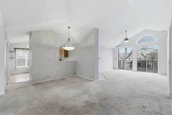 a view of a big room with windows and chandelier