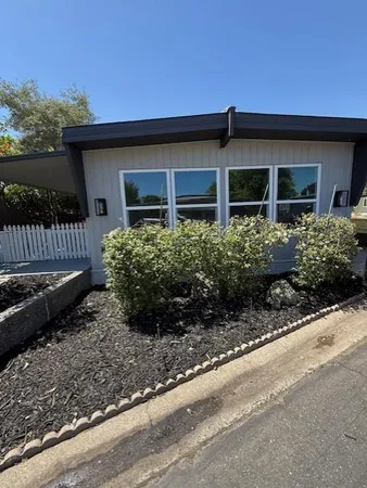 a front view of a house with garden