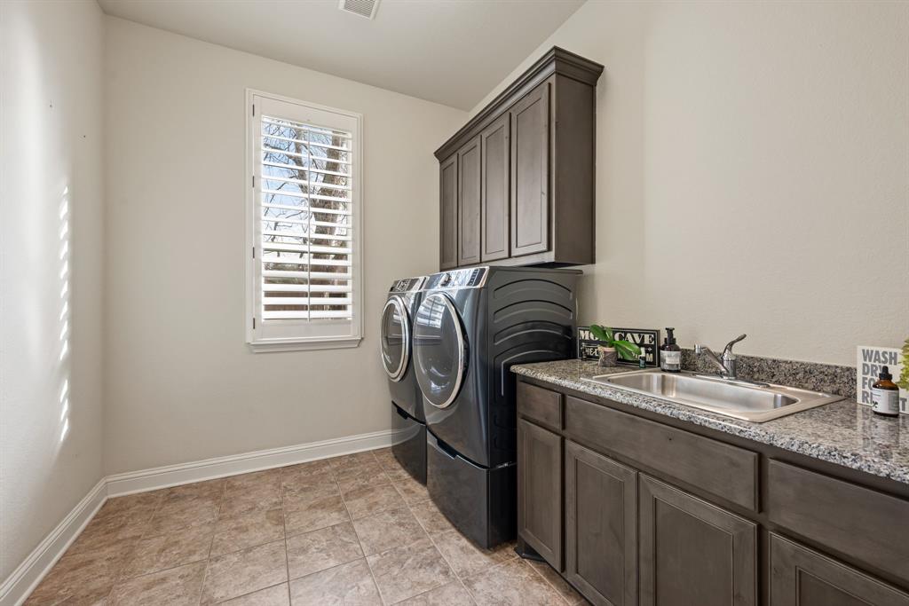448 Rock Springs Road Coppell, TX 75019 - Photo 13 of 40 a utility room with sink dryer and washer
