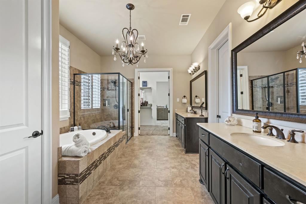 448 Rock Springs Road Coppell, TX 75019 - Photo 15 of 40 a spacious en suite bathroom with a tub sink shower and mirror