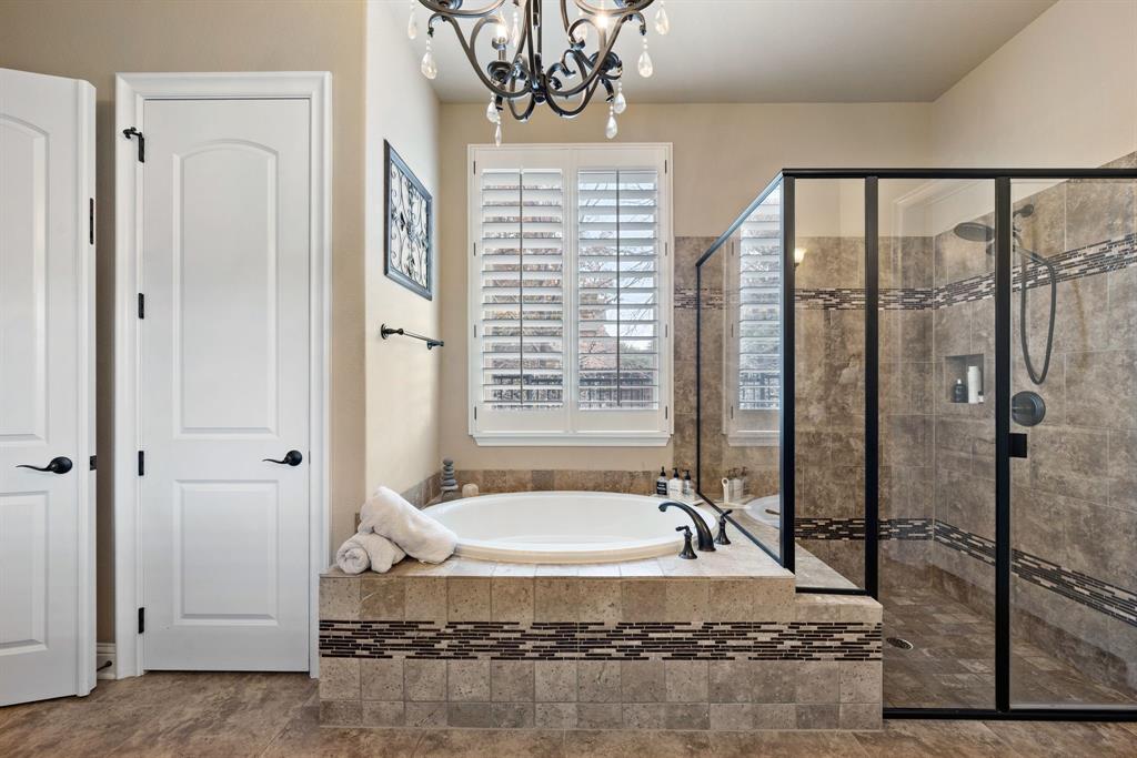 448 Rock Springs Road Coppell, TX 75019 - Photo 16 of 40 a spacious bathroom with a granite countertop tub and a shower