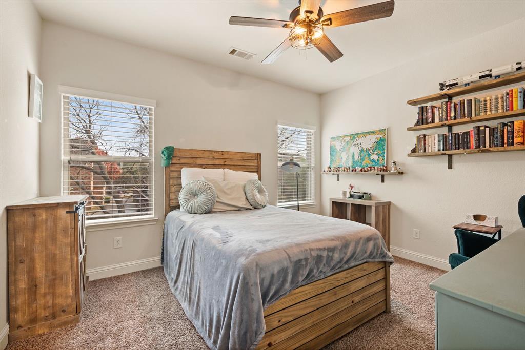 448 Rock Springs Road Coppell, TX 75019 - Photo 19 of 40 a bedroom with a bed bookshelf and a window