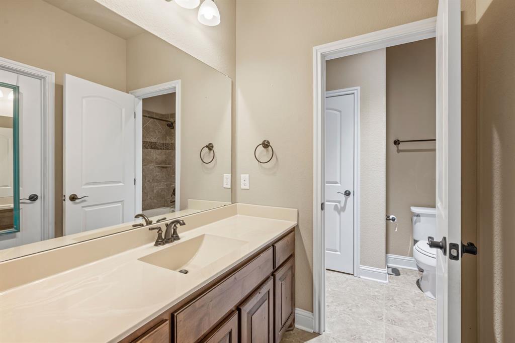 448 Rock Springs Road Coppell, TX 75019 - Photo 22 of 40 a bathroom with a sink vanity granite and a mirror