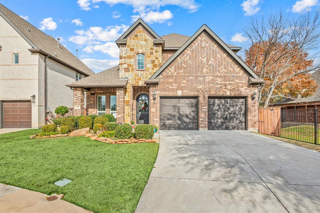 448 Rock Springs Road Coppell, TX 75019 - Photo 40 of 40 a front view of a house with a yard and potted plants