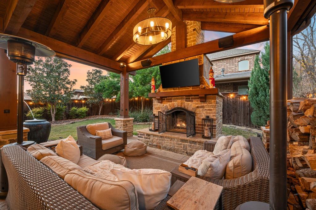 448 Rock Springs Road Coppell, TX 75019 - Photo 5 of 40 a outdoor living space with furniture a fireplace and a floor to ceiling window
