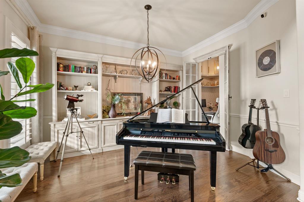 448 Rock Springs Road Coppell, TX 75019 - Photo 9 of 40 a living room with furniture a dining table and paintings on the wall