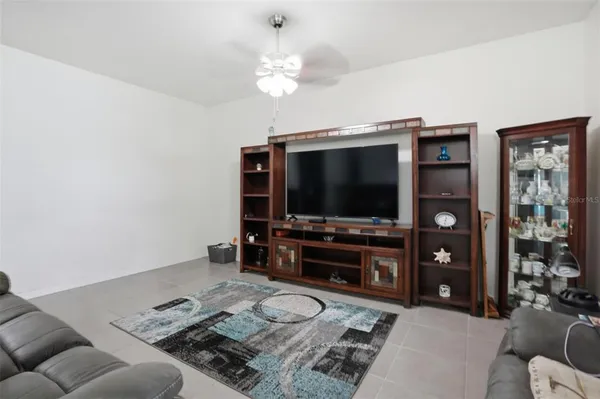 a living room with furniture and a view of kitchen