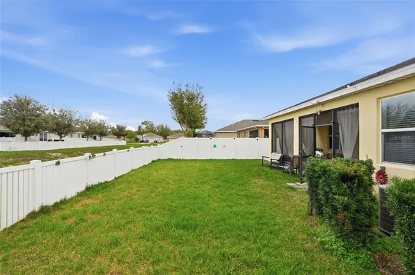 a view of a house with backyard and porch