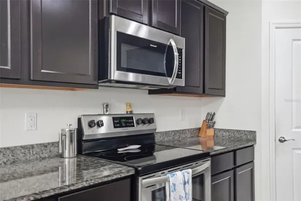a kitchen with a refrigerator and cabinets