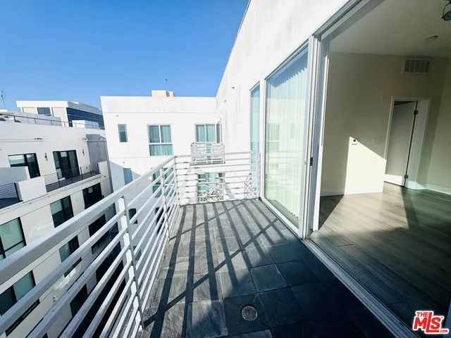 a view of a living room with furniture and wooden floor