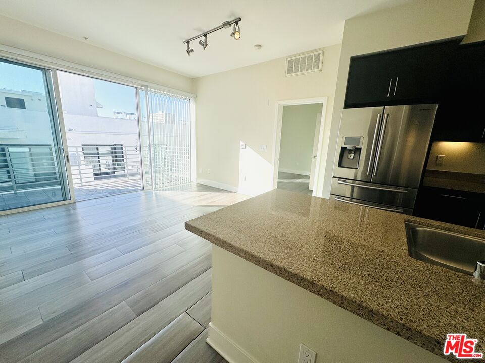 1241 5th Street, Unit 502 Santa Monica, CA 90401 - Photo 22 of 33 a view of kitchen island wooden floor