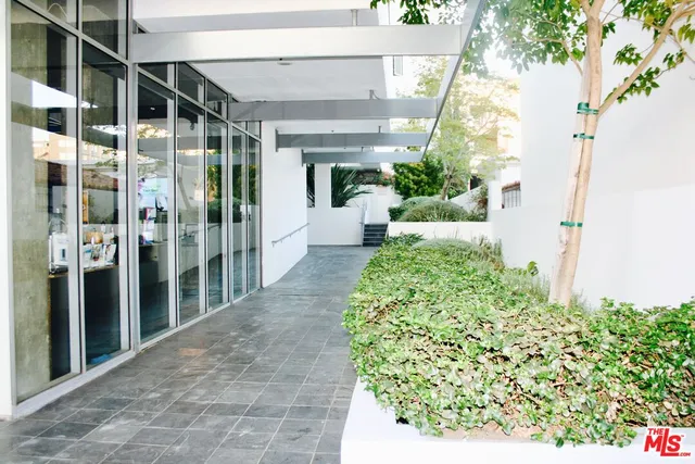 a front view of a building and trees