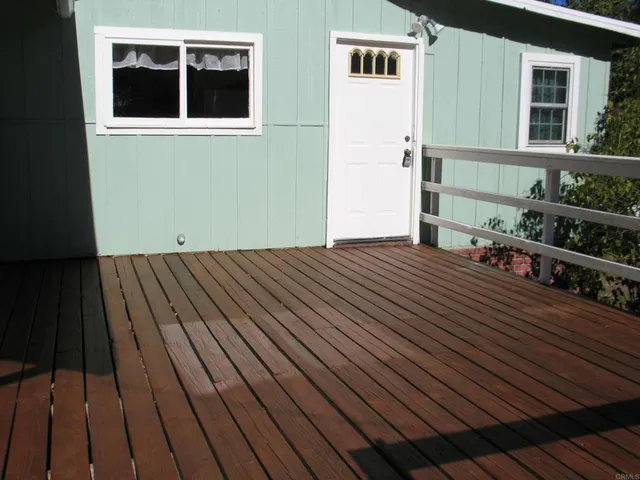a view of backyard with a deck