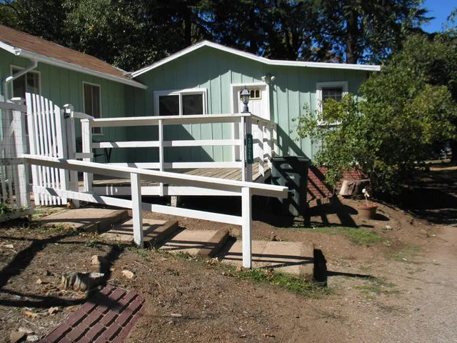 a view of a house with a wooden fence
