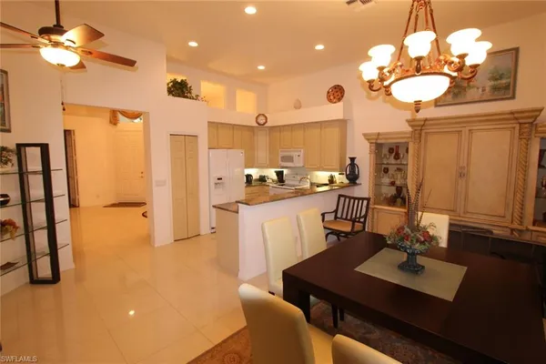 a view of a dining room with furniture and a chandelier