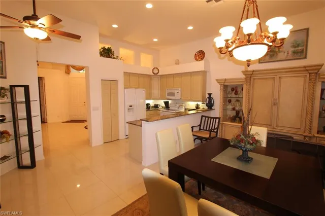 a view of a dining room with furniture and a chandelier