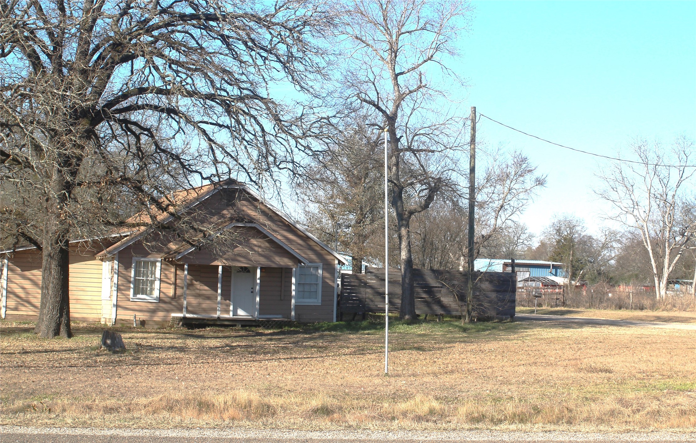 592 Burr Road Madisonville, TX 77864 - Photo 4 of 5 a view of a house with a yard covered in snow