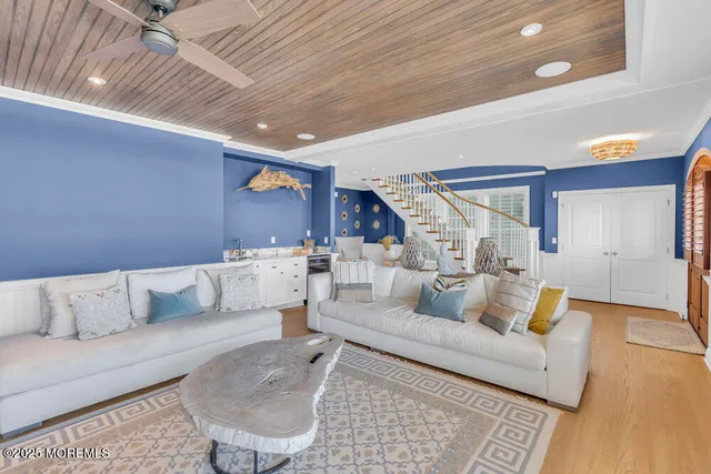 a dining room with furniture a chandelier and wooden floor