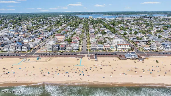 a dining room with furniture a chandelier and window