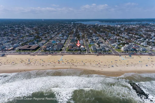 a dining room with furniture a chandelier and wooden floor