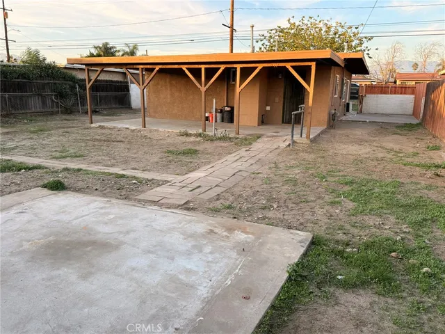 a view of a wooden house with a yard