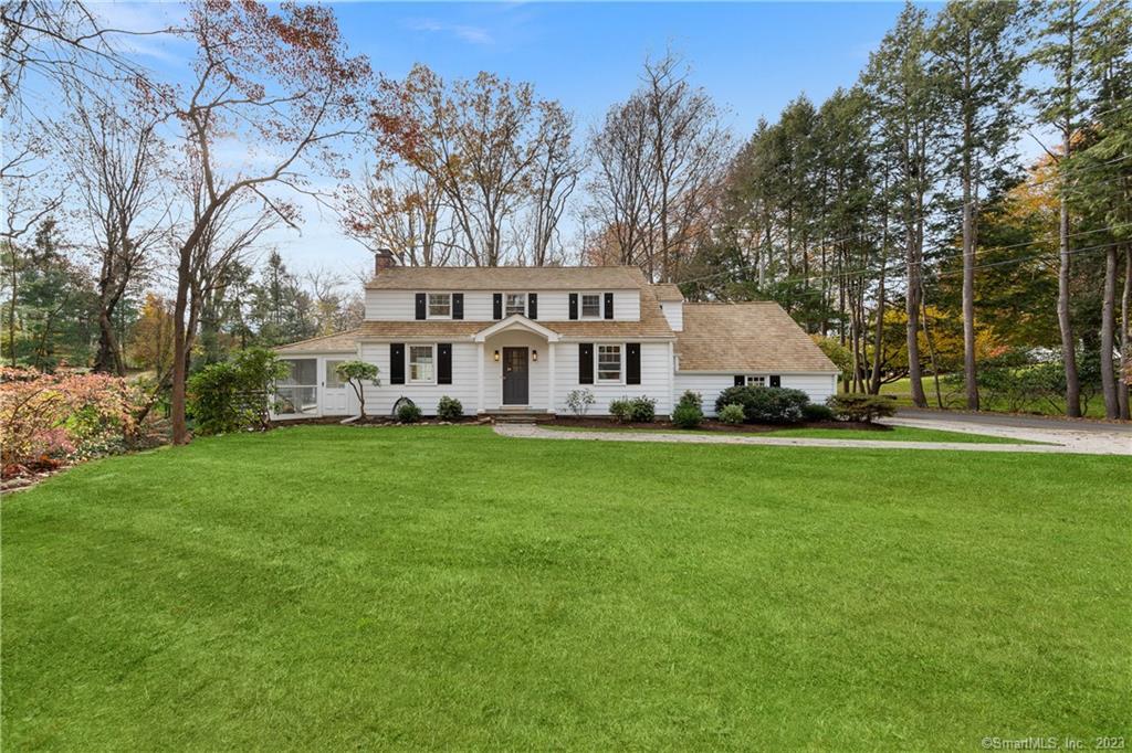 71 Cavalry Road Westport, CT 06880 - Photo 1 of 1 a view of a white house in front of a big yard with large trees