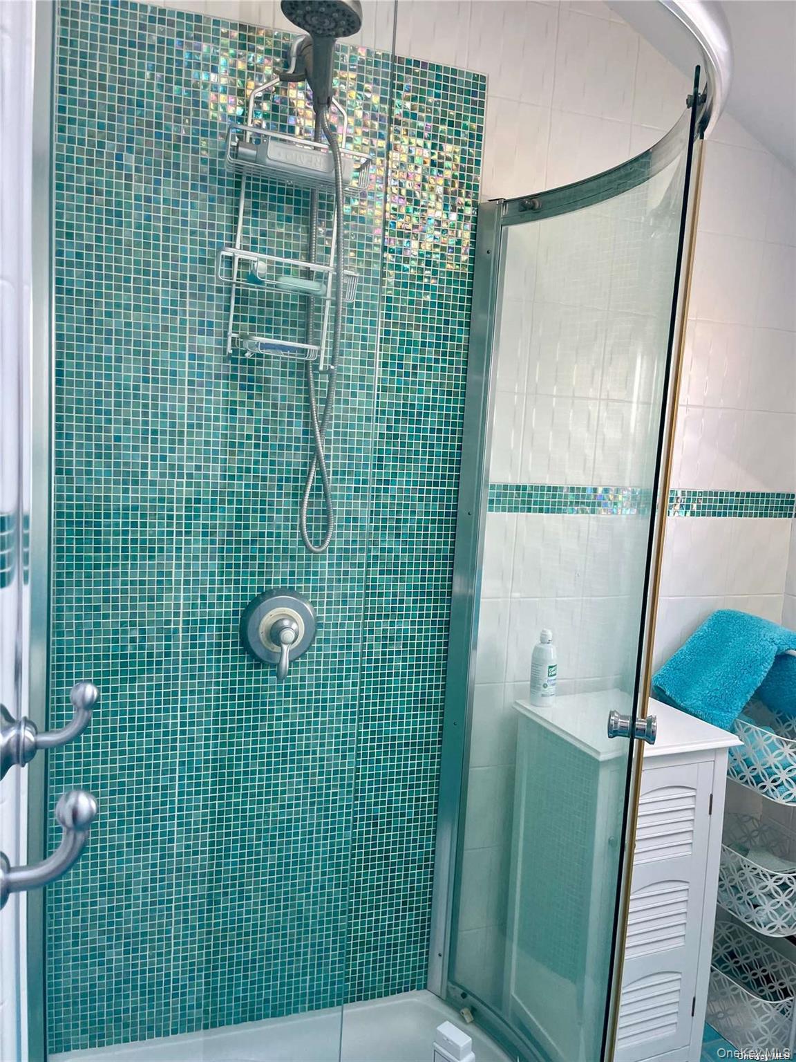 89 Lynbrook Avenue Point Lookout, NY 11569 - Photo 13 of 19 a bathroom with a green shower and a sink
