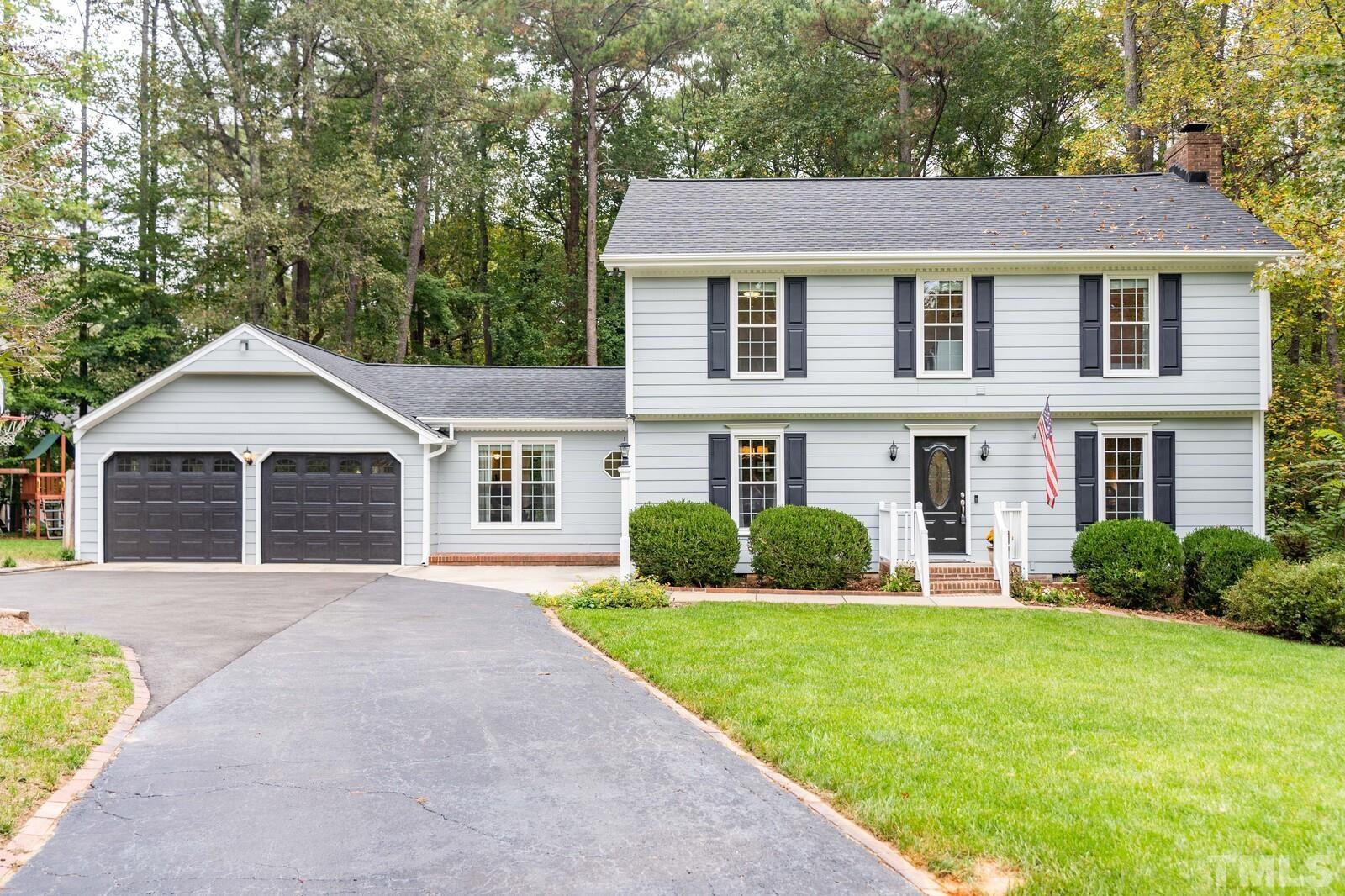 8312 Heel Stone Court Raleigh, NC 27613 - Photo 1 of 30 a front view of a house with a yard and garage
