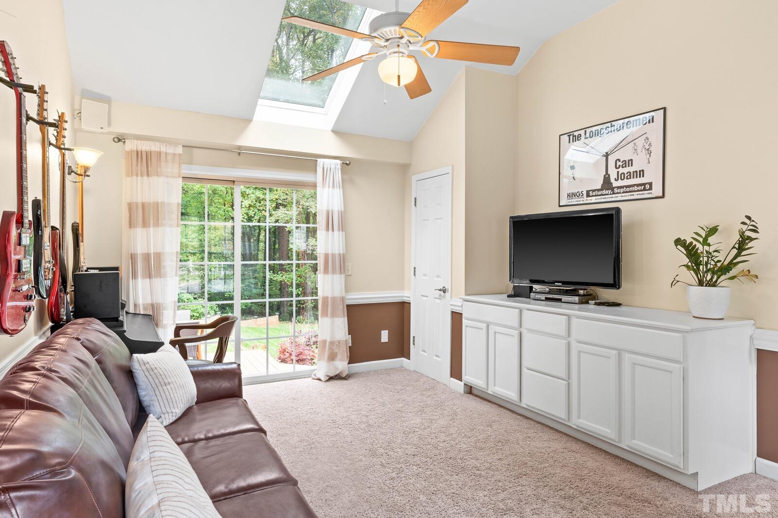8312 Heel Stone Court Raleigh, NC 27613 - Photo 13 of 30 a bedroom with a bed and a flat screen tv