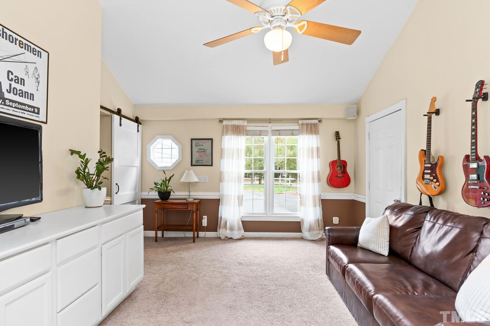 8312 Heel Stone Court Raleigh, NC 27613 - Photo 14 of 30 a living room with furniture and a flat screen tv