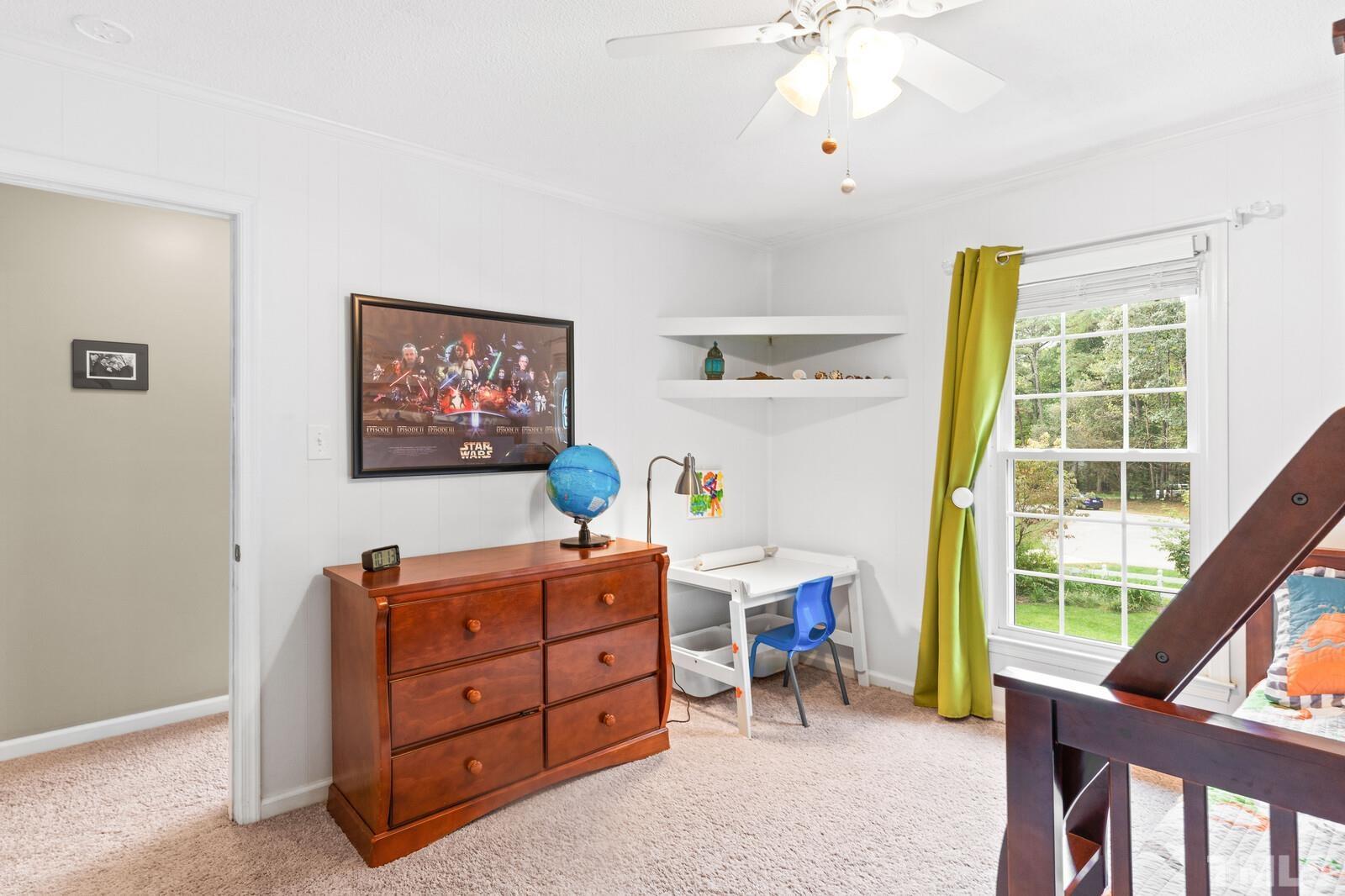 8312 Heel Stone Court Raleigh, NC 27613 - Photo 22 of 30 a bed room with a bed and a desk