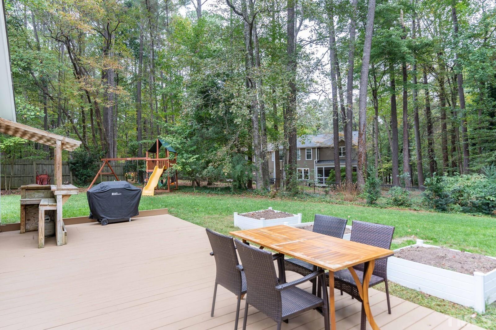 8312 Heel Stone Court Raleigh, NC 27613 - Photo 24 of 30 a view of a table and chairs in the garden