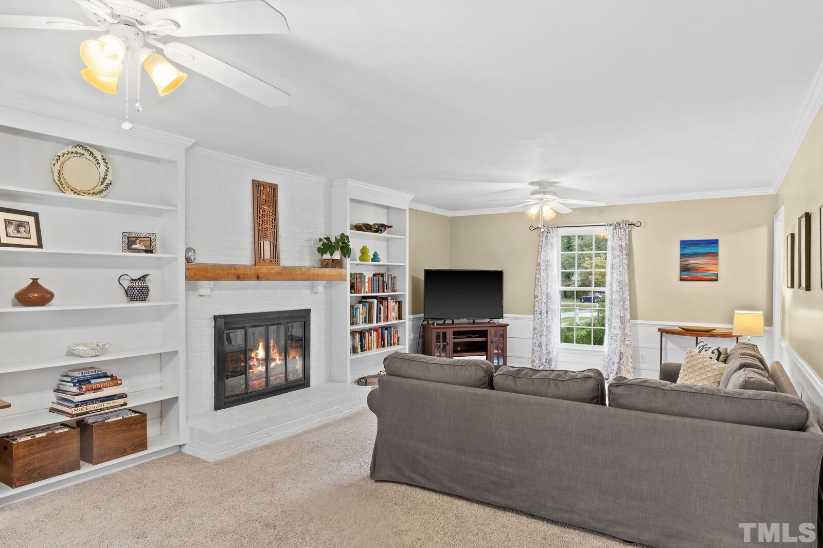 8312 Heel Stone Court Raleigh, NC 27613 - Photo 5 of 30 a living room with furniture and a fireplace