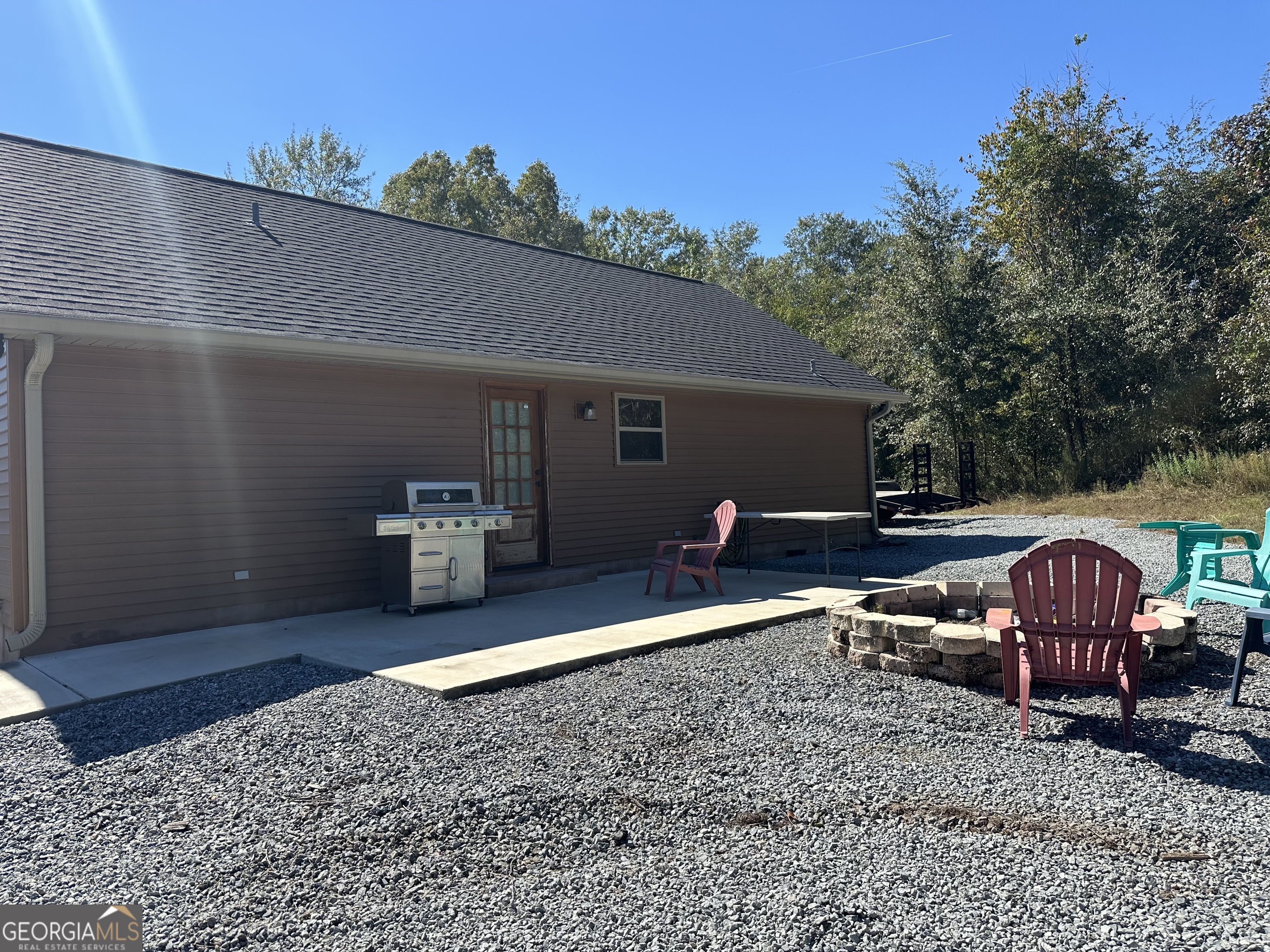 68 Sand Rdg Road Rhine, GA 31077 - Photo 13 of 54 a view of a backyard with table and chairs under an umbrella
