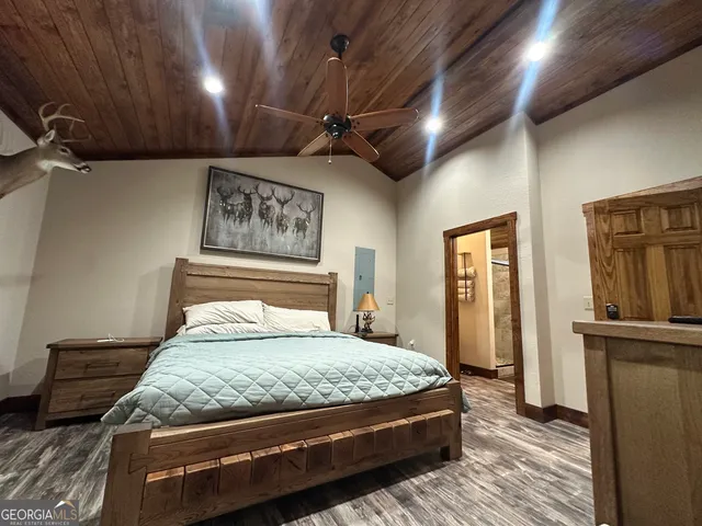 a bed sitting in a bedroom and tv