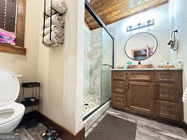 a bathroom with a toilet a sink and a mirror