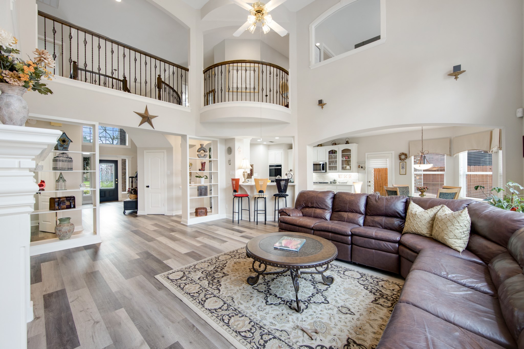 9510 Ashdown Forest Drive Spring, TX 77379 - Photo 20 of 50 LIVING ROOM – dramatic living space with soaring ceilings and abundant natural light. The open layout connects seamlessly with the kitchen and breakfast area.