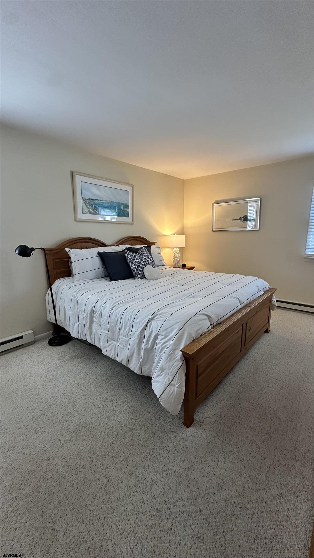 3 Sandy Lane Brigantine, NJ 08203 - Photo 4 of 11 a bedroom with a bed rug and lamp