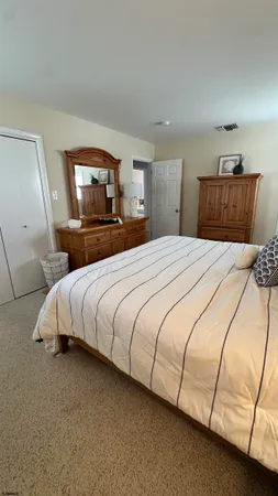 a bedroom with a bed and a night stand