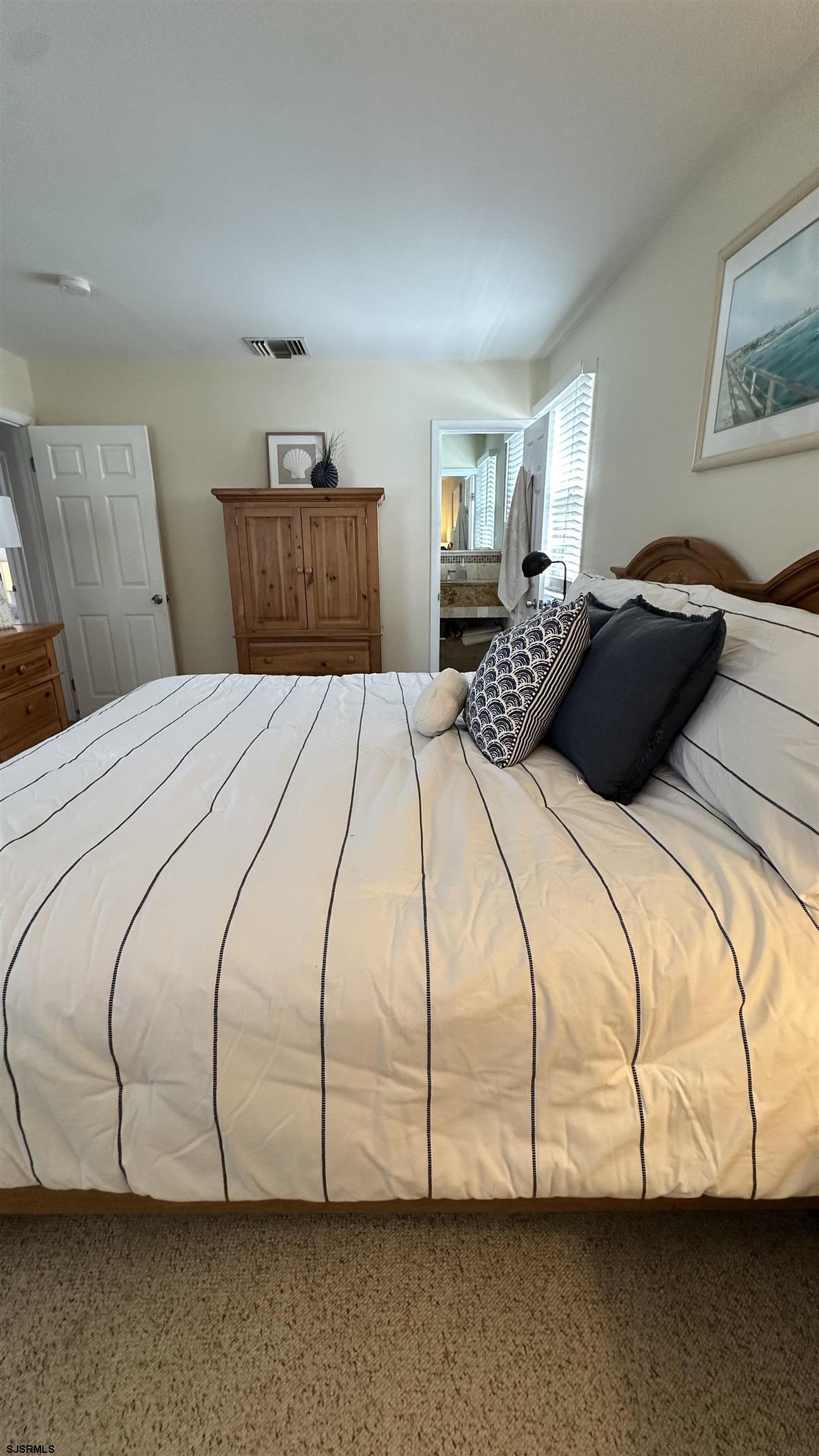 3 Sandy Lane Brigantine, NJ 08203 - Photo 6 of 11 a bedroom with a bed and dresser
