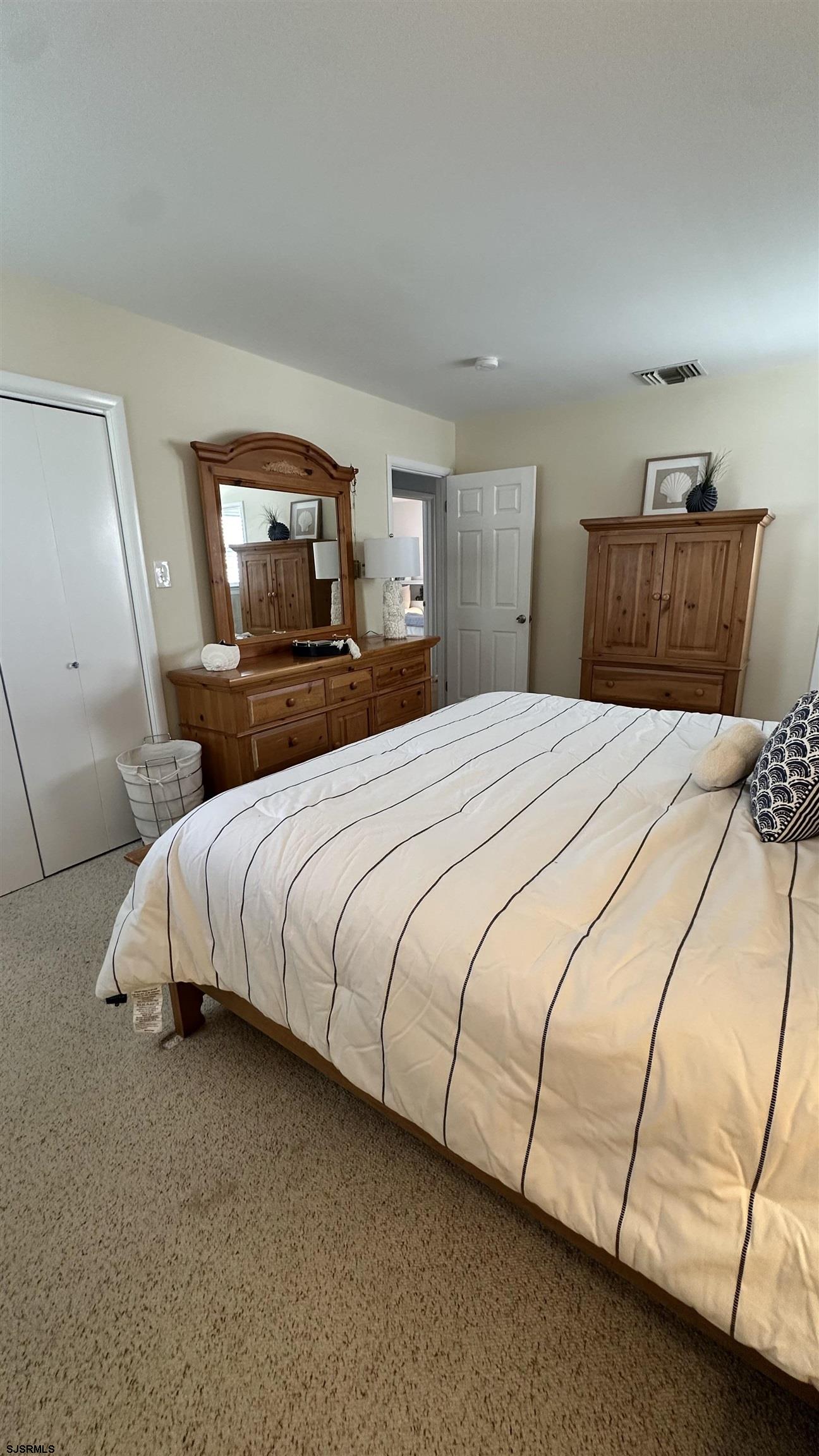 3 Sandy Lane Brigantine, NJ 08203 - Photo 7 of 11 a bedroom with a bed and a night stand