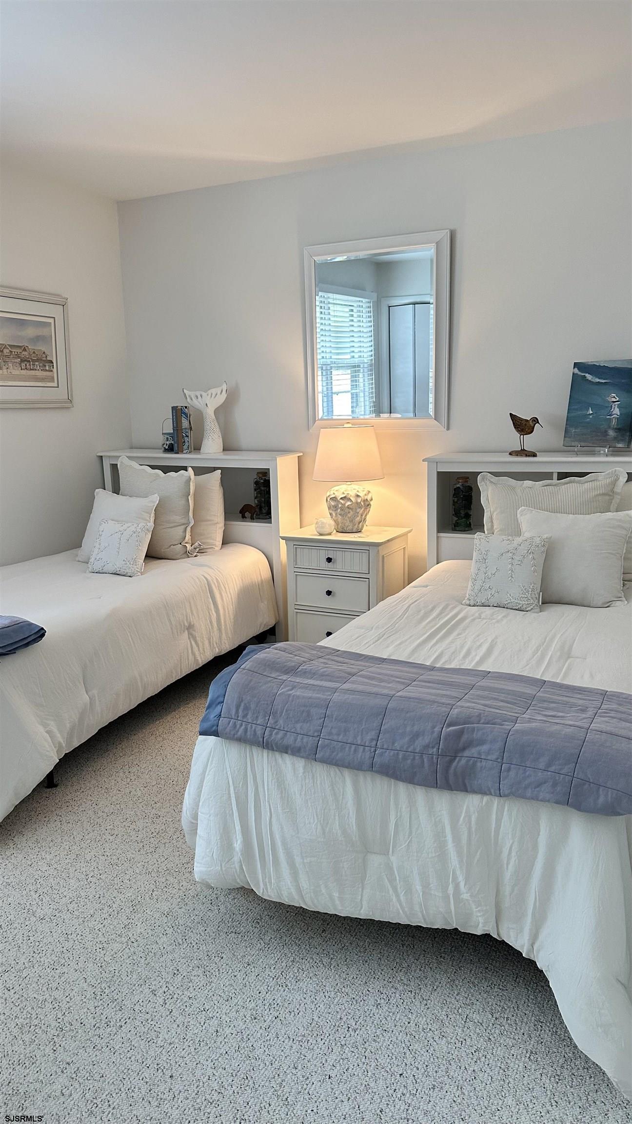 3 Sandy Lane Brigantine, NJ 08203 - Photo 8 of 11 a bedroom with two beds and painting on the wall