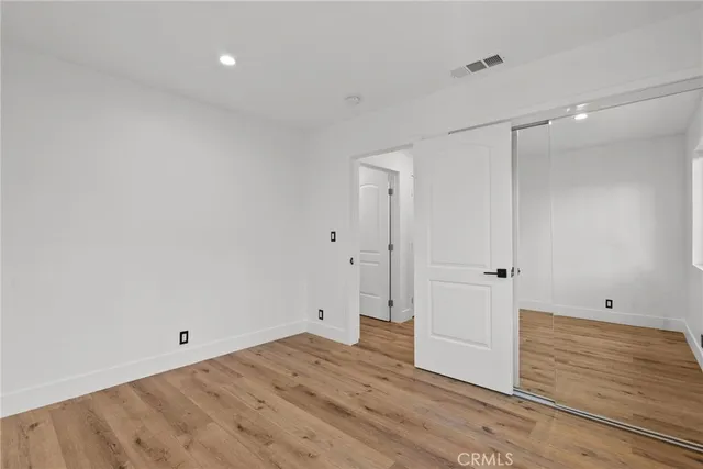 a view of room with wooden floor