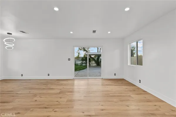 a view of room with wooden floor