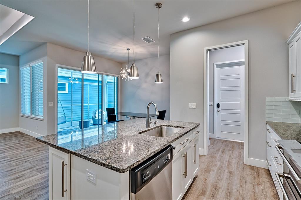 6464 Southwest 77th Street Gainesville, FL 32608 - Photo 2 of 41 a kitchen with granite countertop a sink a counter space appliances and cabinets