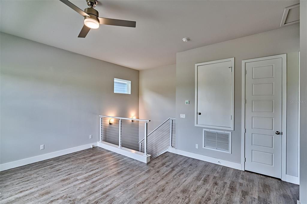 6464 Southwest 77th Street Gainesville, FL 32608 - Photo 27 of 41 an empty room with wooden floor cabinet and windows
