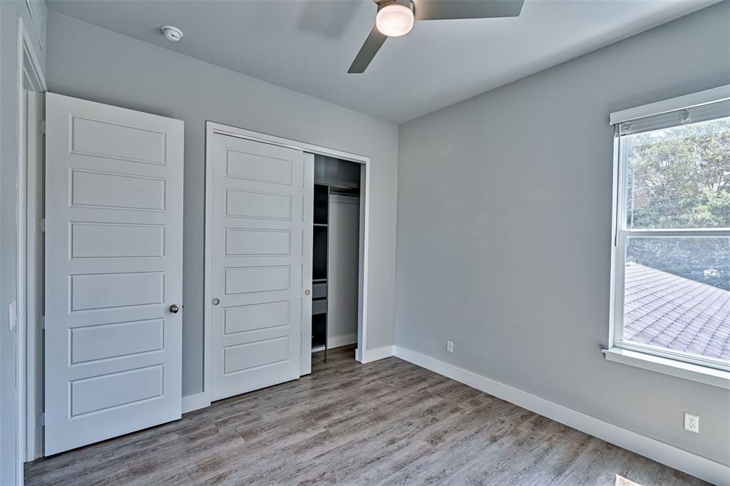 6464 Southwest 77th Street Gainesville, FL 32608 - Photo 30 of 41 an empty room with wooden floor cabinet and windows