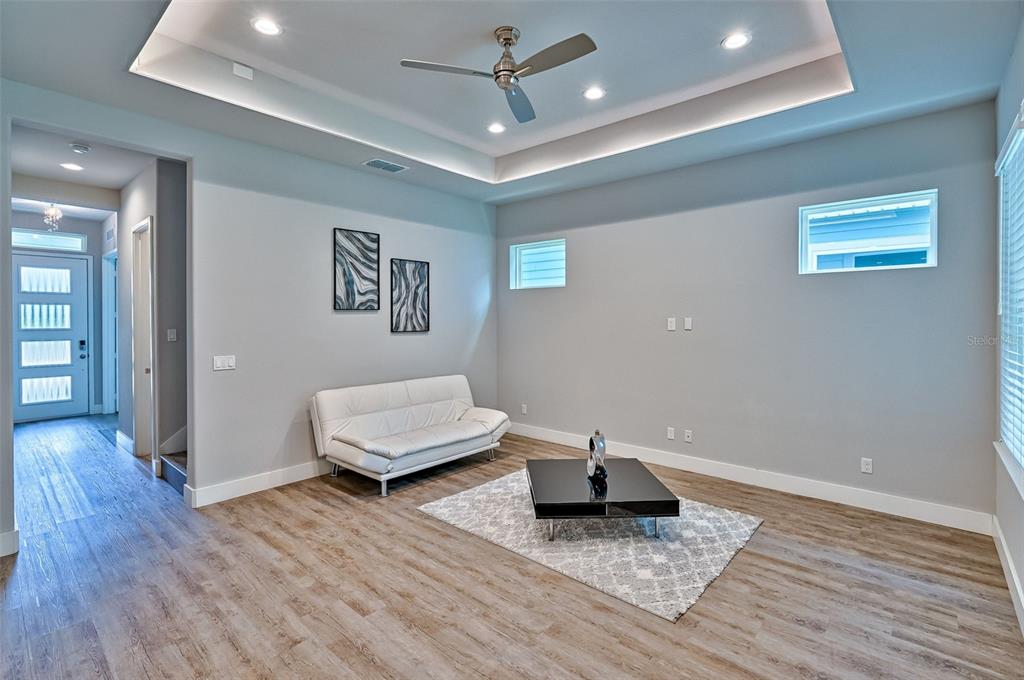 6464 Southwest 77th Street Gainesville, FL 32608 - Photo 3 of 41 a living room with wooden floor and a ceiling fan
