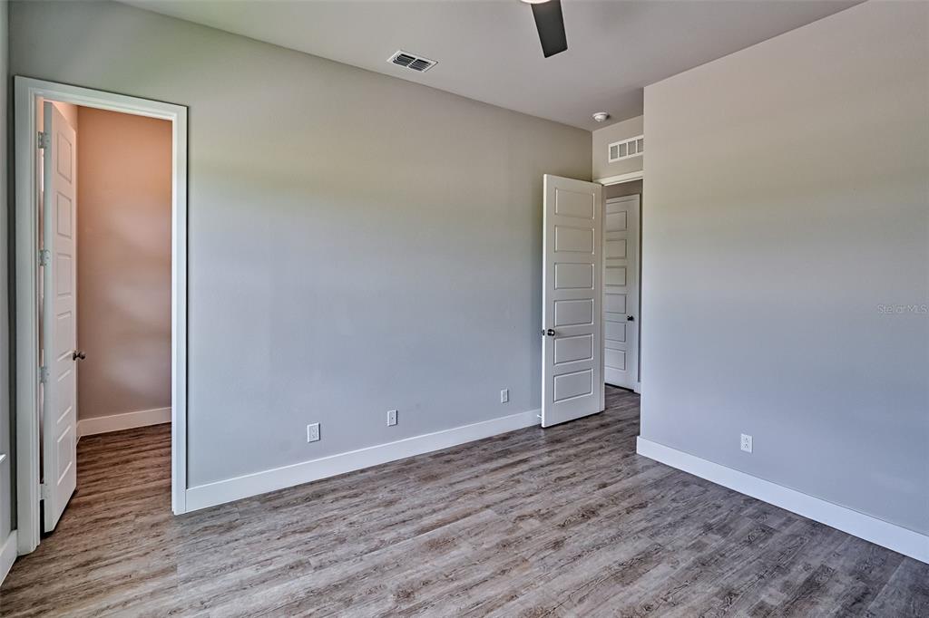 6464 Southwest 77th Street Gainesville, FL 32608 - Photo 34 of 41 an empty room with wooden floor and closet