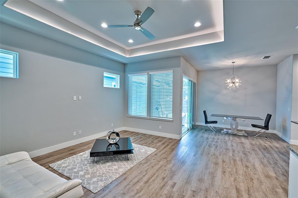 6464 Southwest 77th Street Gainesville, FL 32608 - Photo 7 of 41 a living room with furniture and a chandelier